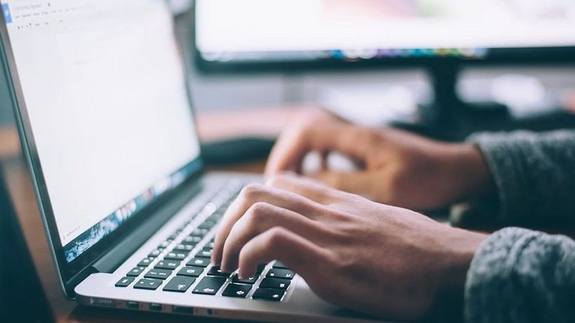 Fingers typing on a keyboard.