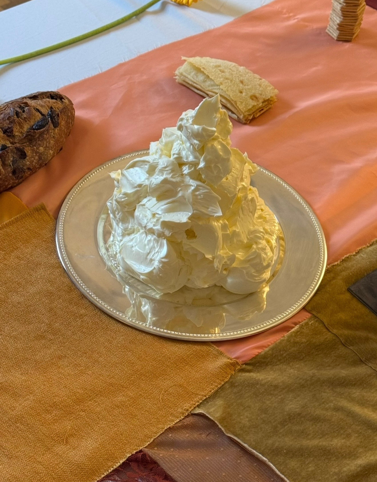 a stainless steel plate with a mountain of whipped butter