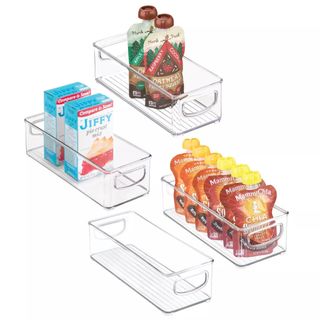 Clear plastic storage bins holding pantry goods