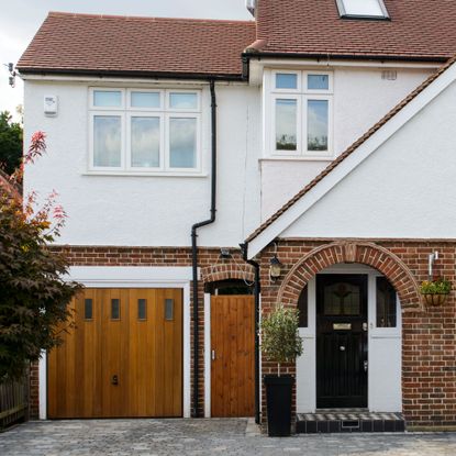 sloping roof house with white windows and grey door