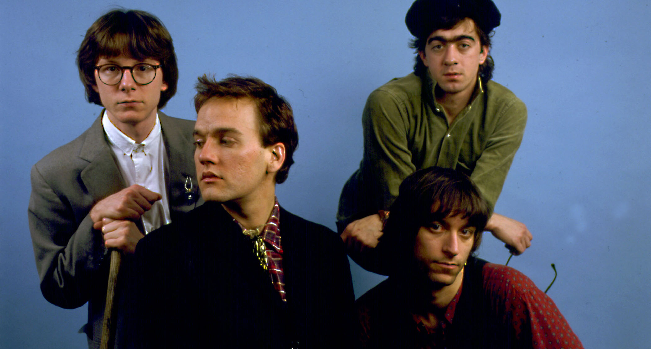 R.E.M. photographed in 1985: [from left] Mike Mills, Michael Stipe, Peter Buck [sitting] and Bill Berry.