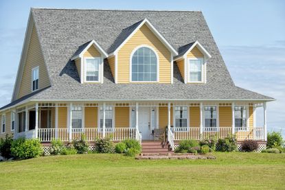 yellow farmhouse on a flat lot