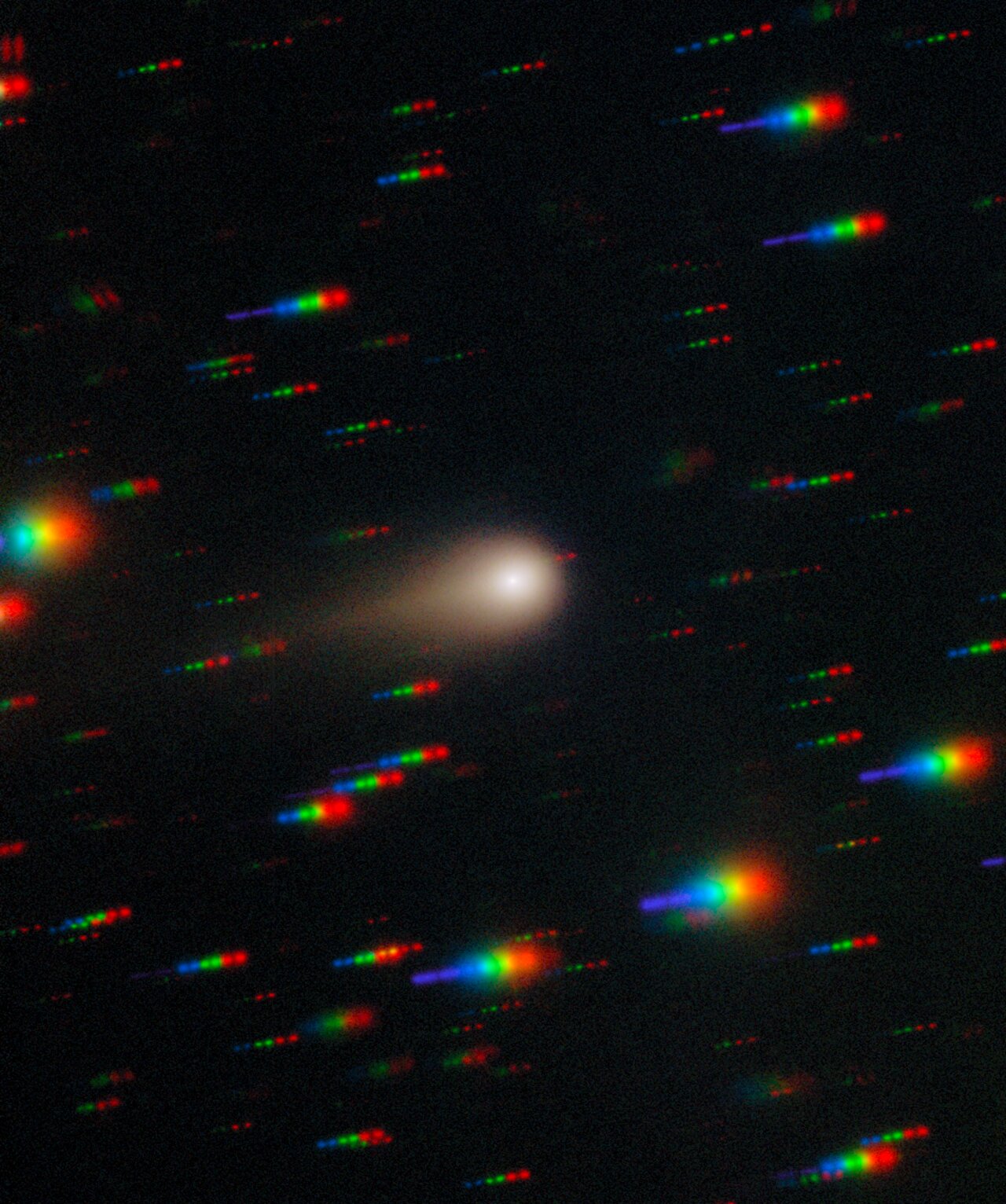 a blurry white smudge on a black background dotted with colorful stars