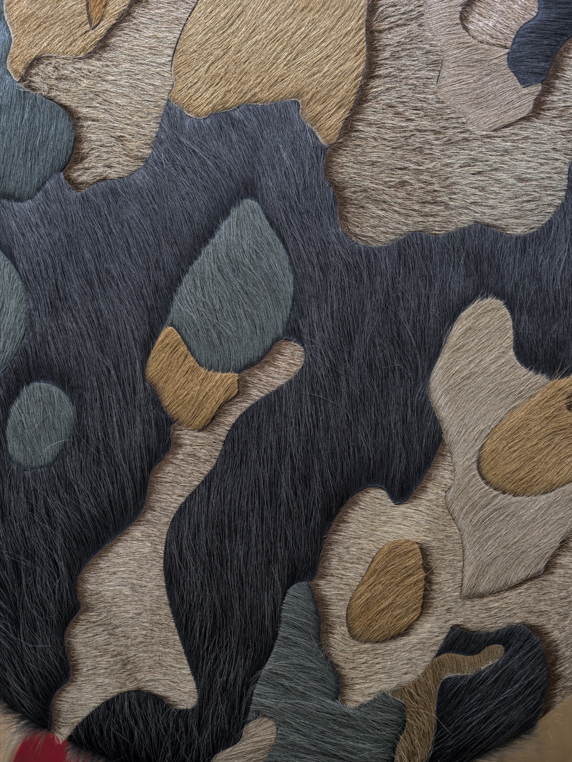 poufs with organic shapes made from animal hair on hide