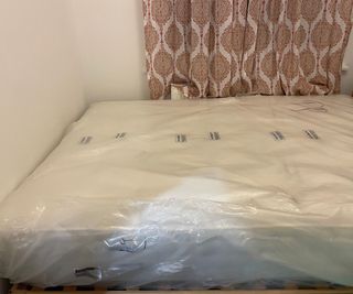 Woolroom Hebridean 3000 in plastic wrap on a bed.