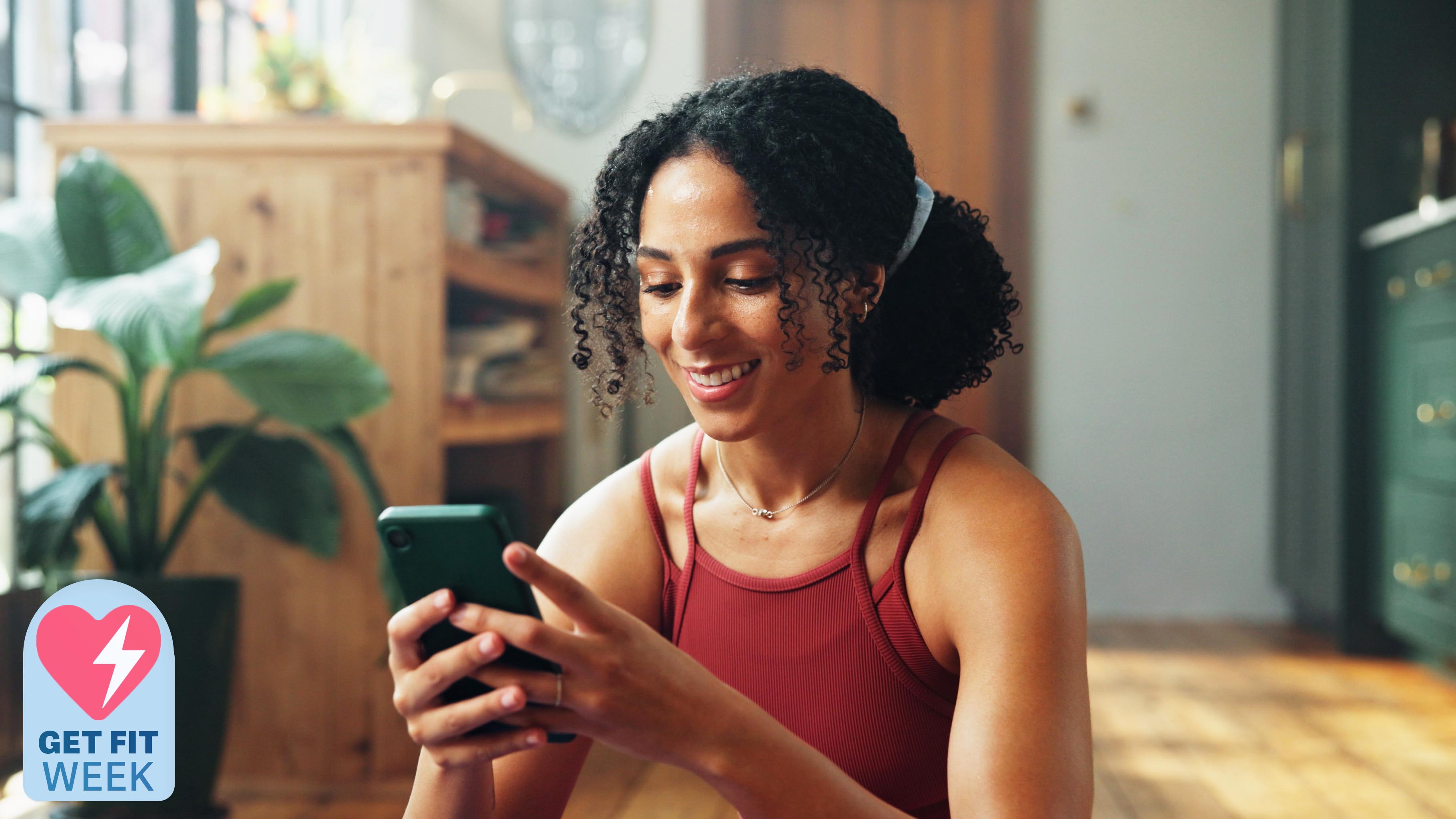 a woman in gym kit looking at her phone
