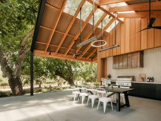 A large outdoor kitchen with a gable roof