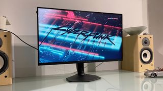 Alienware AW2725QF monitor on desk showing Cyberpunk 2077 main screen