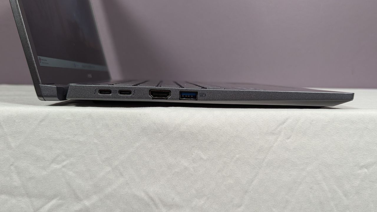 Acer Aspire 14 AI's left-side ports on a white table against a gray background.