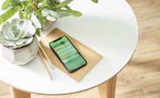 Wiser app on a phone on a table for smart heating