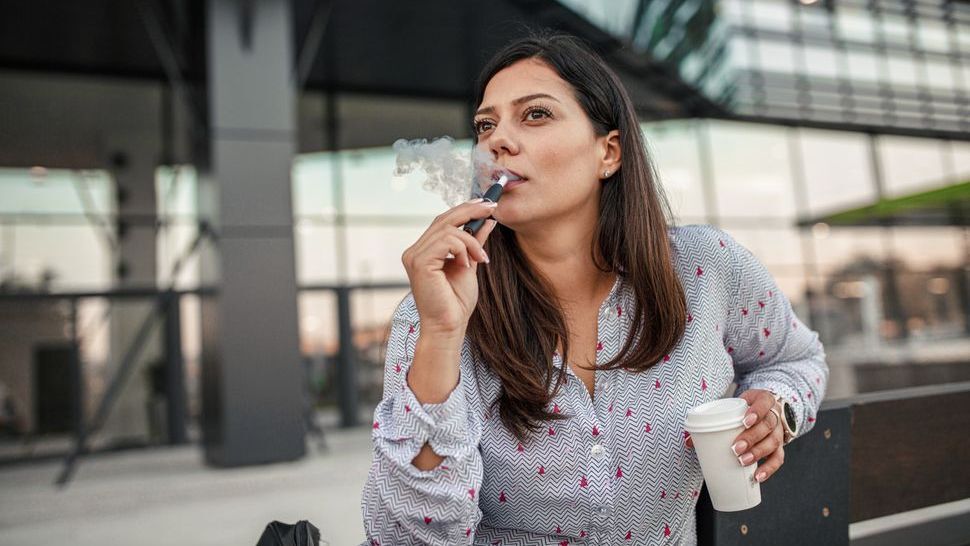 woman vaping with an e-cigarette