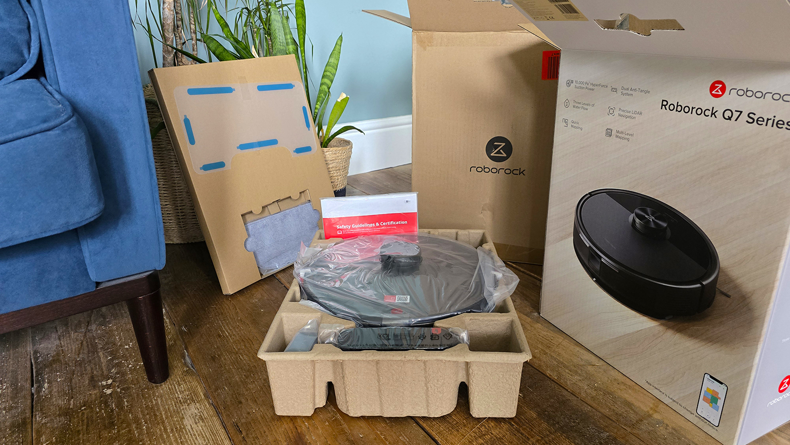 Roborock Q7 M5 in box on wooden floor