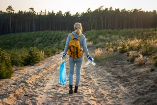 how to be a better adventurer: woman cleaning trail