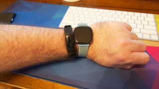 The Fitbit Versa 3 and Inspire 2 worn on a wrist.