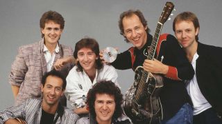 Dire Straits group portrait, with Mark Knopfler holding out a CD