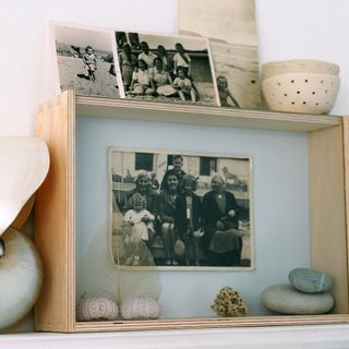 Wooden box with sepia photos and stones