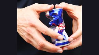 Crushed Red Bull can in a person's hands