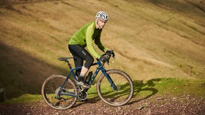 Image shows a cyclist riding one of the best gravel bikes