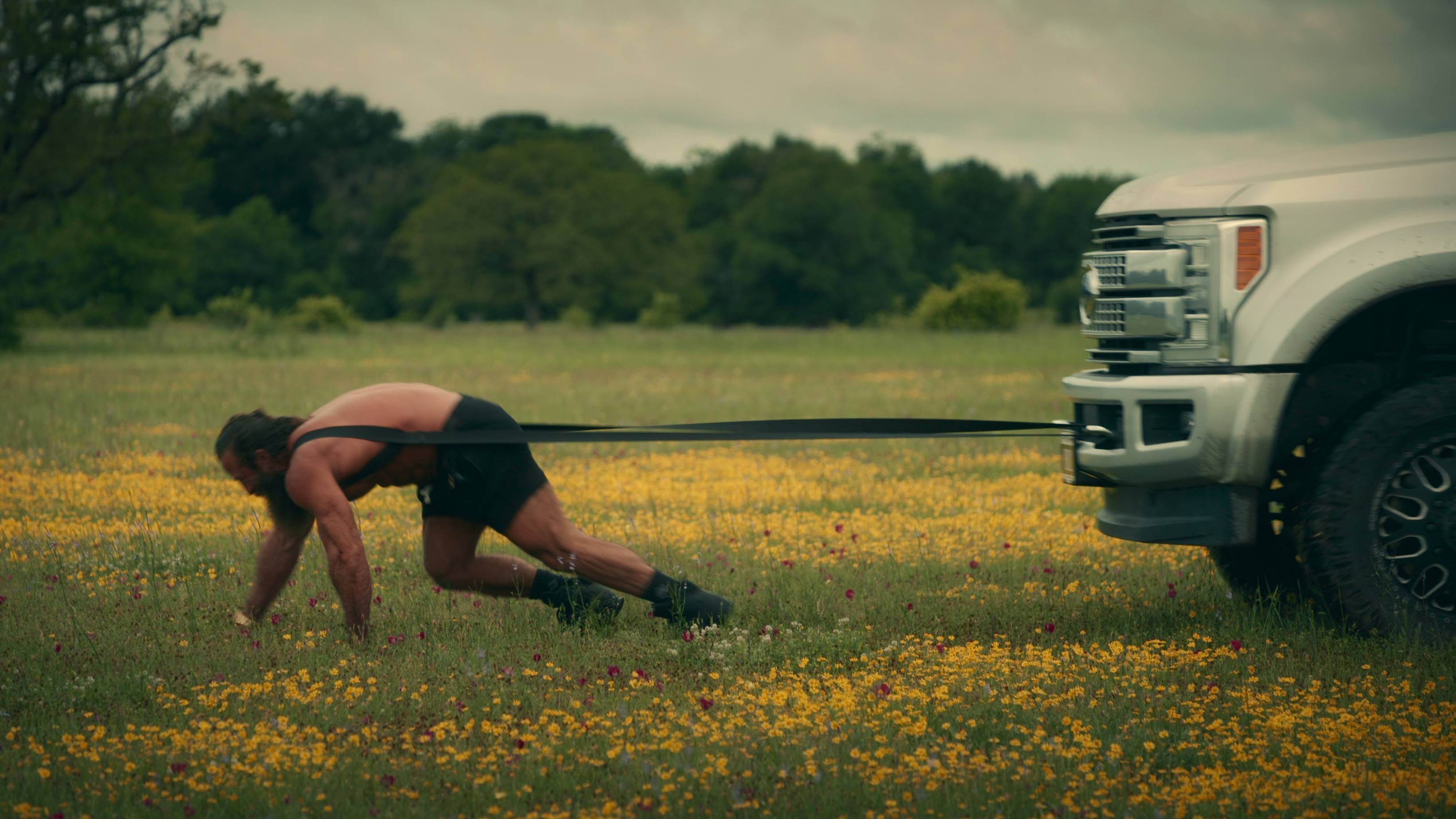 Brian Johnson pulling a car in Untold: The Liver King