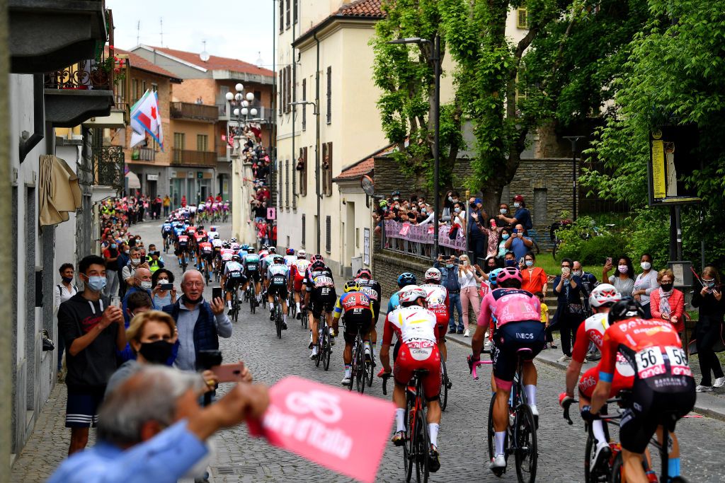 NOVARA ITALY MAY 09 Filippo Ganna of Italy and Team INEOS Grenadiers Pink Leader Jersey The peloton passing through Santena Village landscape during the 104th Giro dItalia 2021 Stage 2 a 179km stage from Stupinigi Nichelino to Novara Public Fans girodiitalia Giro UCIworldtour on May 09 2021 in Novara Italy Photo by Tim de WaeleGetty Images