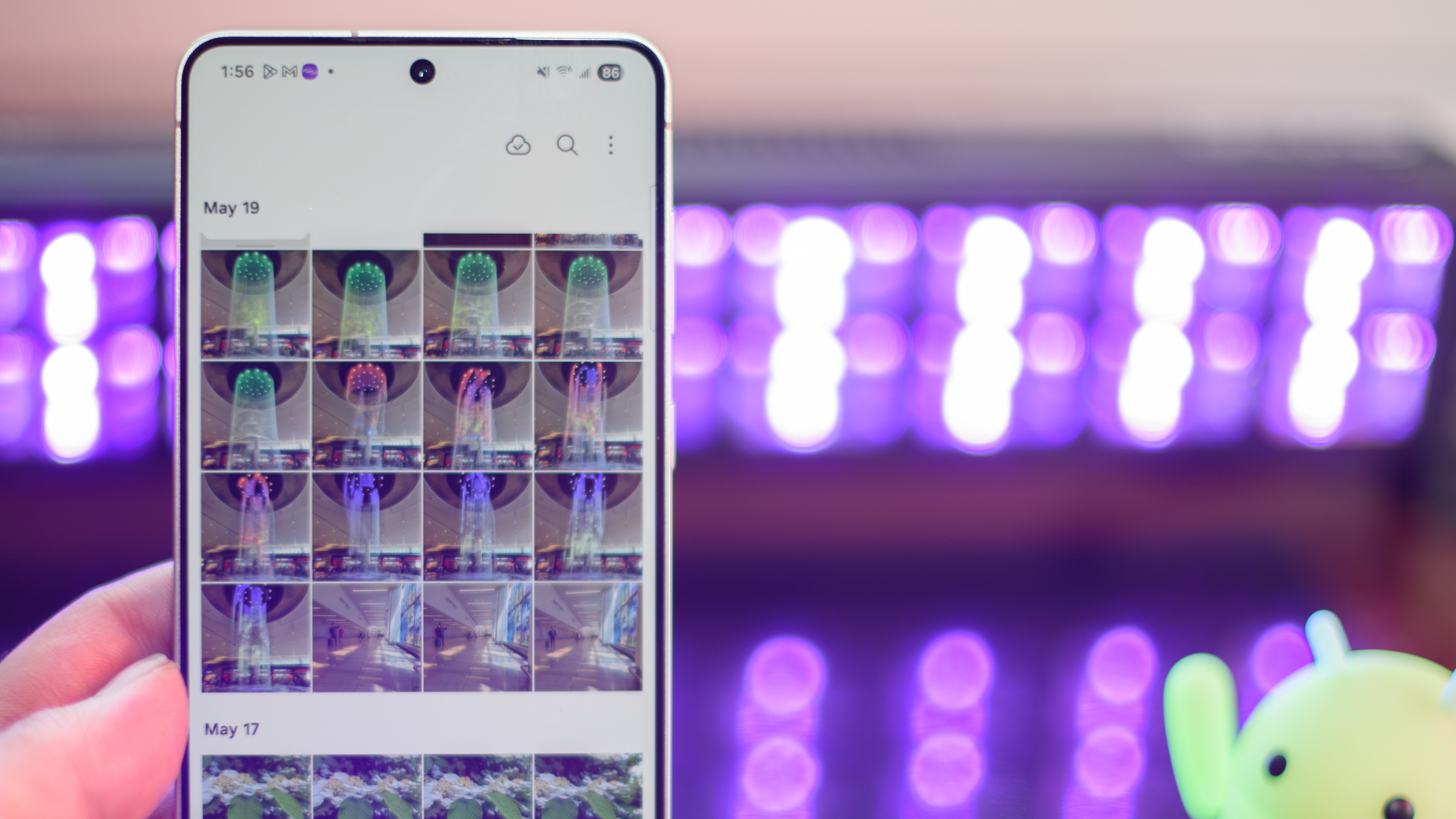 Samsung Galaxy S25 Edge showing the photo Gallery app with black lights blurred in the background