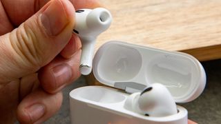 a closeup of the AirPods Pro (2019) being lifted out of their case