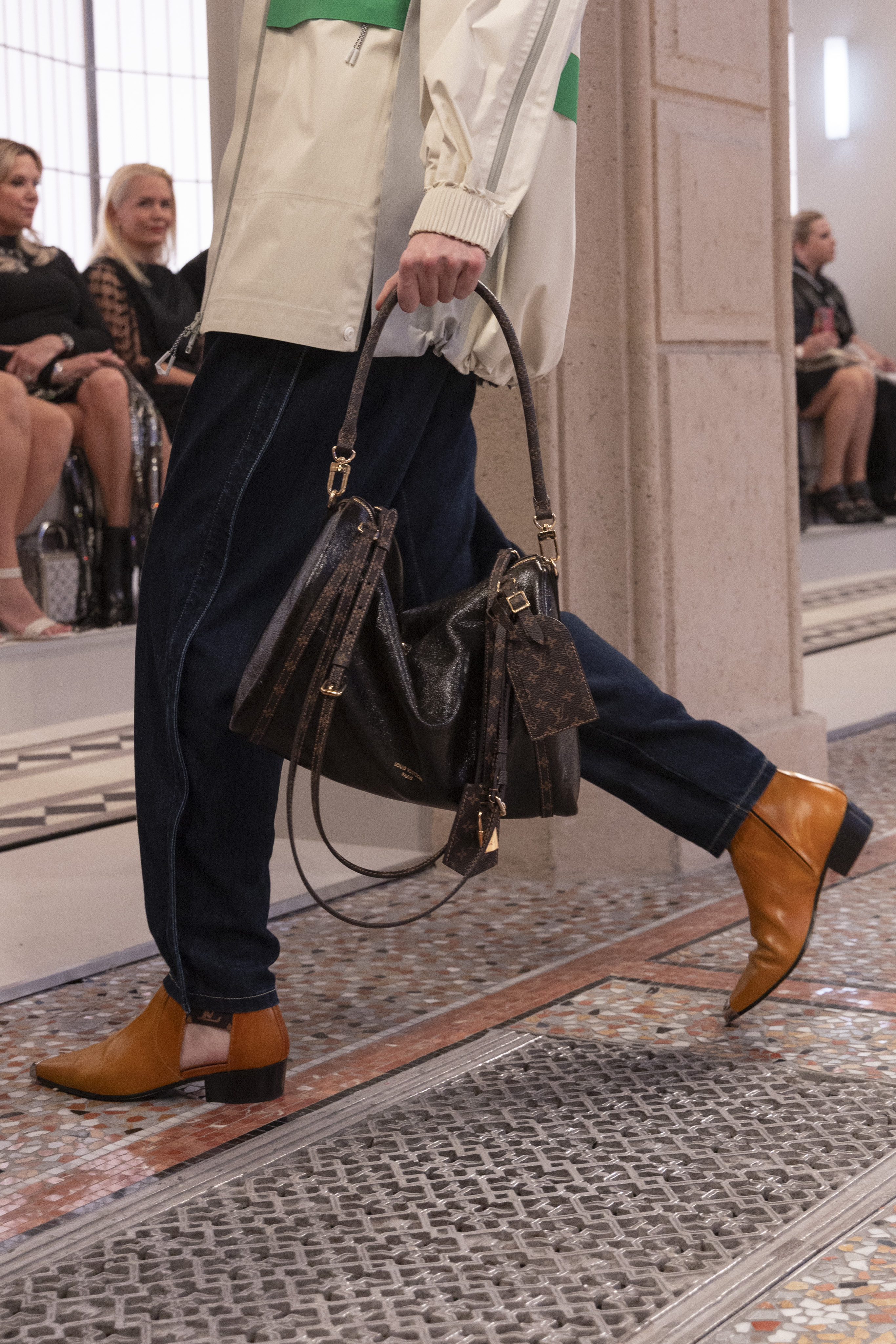 Model on the runway carrying the Louis Vuitton Express bag.