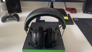 The Razer BlackShark V3 Pro headset on its box on a desk