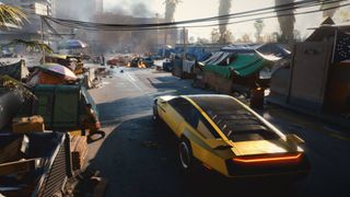 A gold car in Cyberpunk 2077 parked next to a homeless camp.