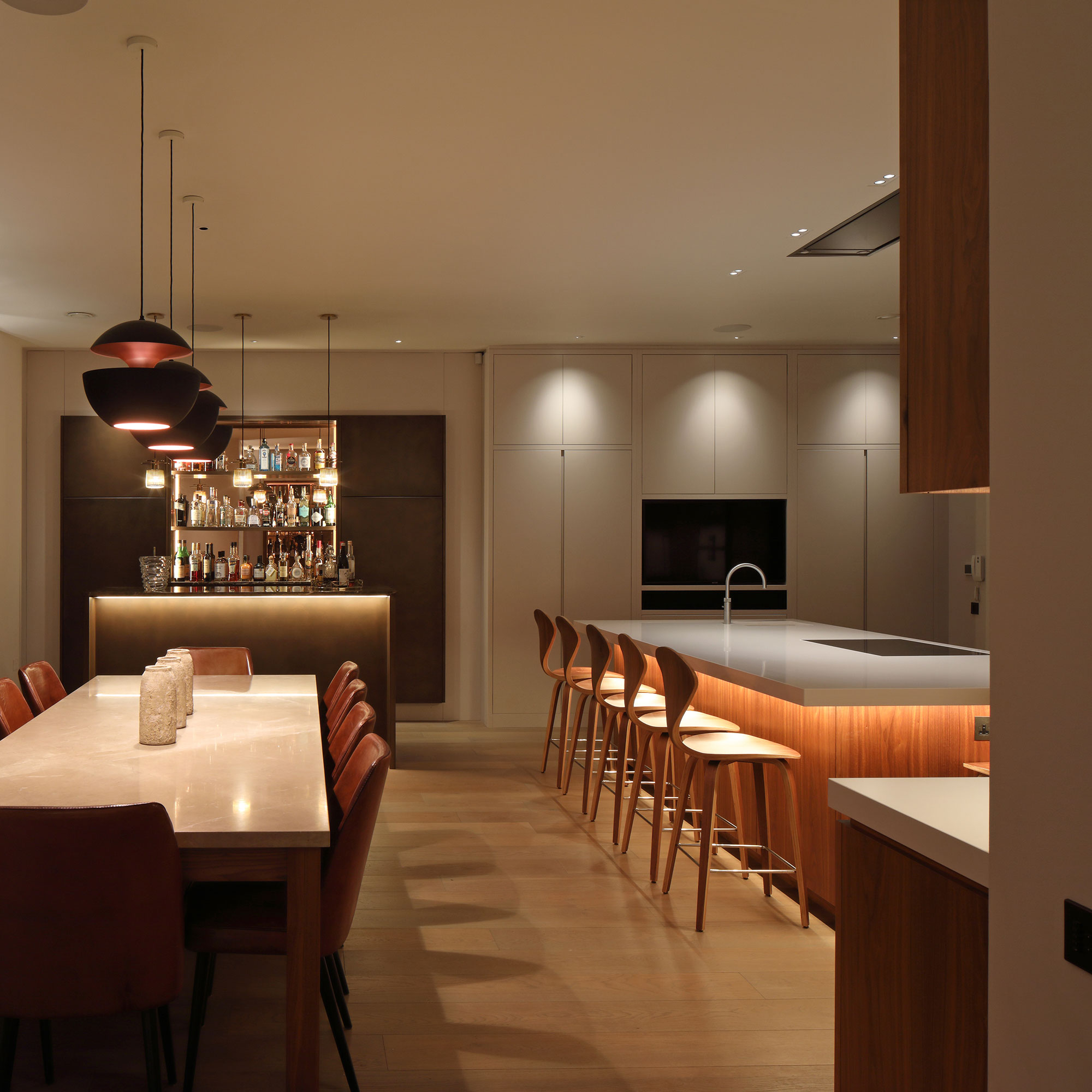 contemporary open plan kitchen diner with layered lighting scheme
