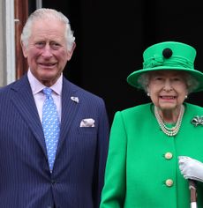 Prince Charles and Queen Elizabeth standing next to each other and smiling