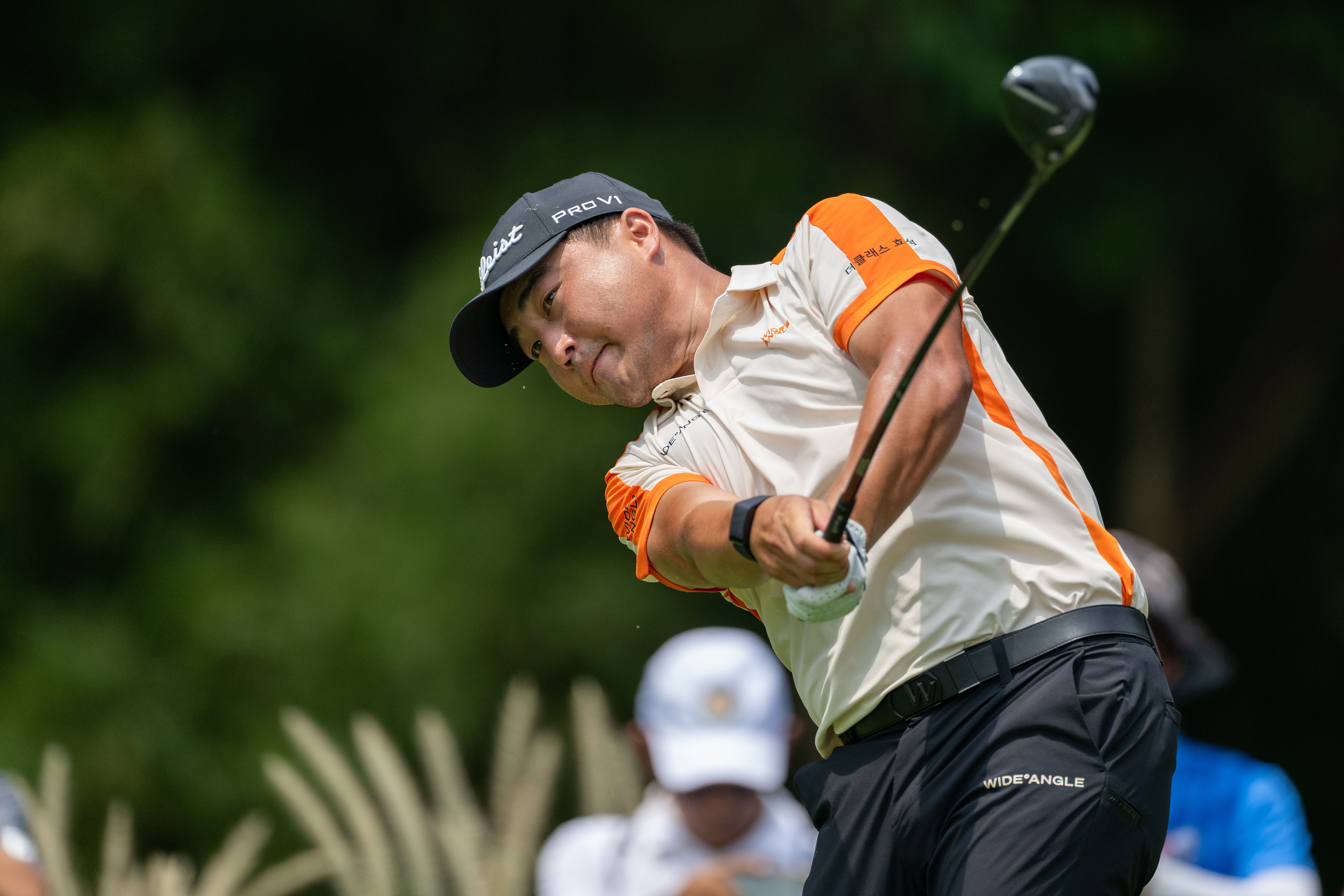 Richard T Lee hits a fairway wood