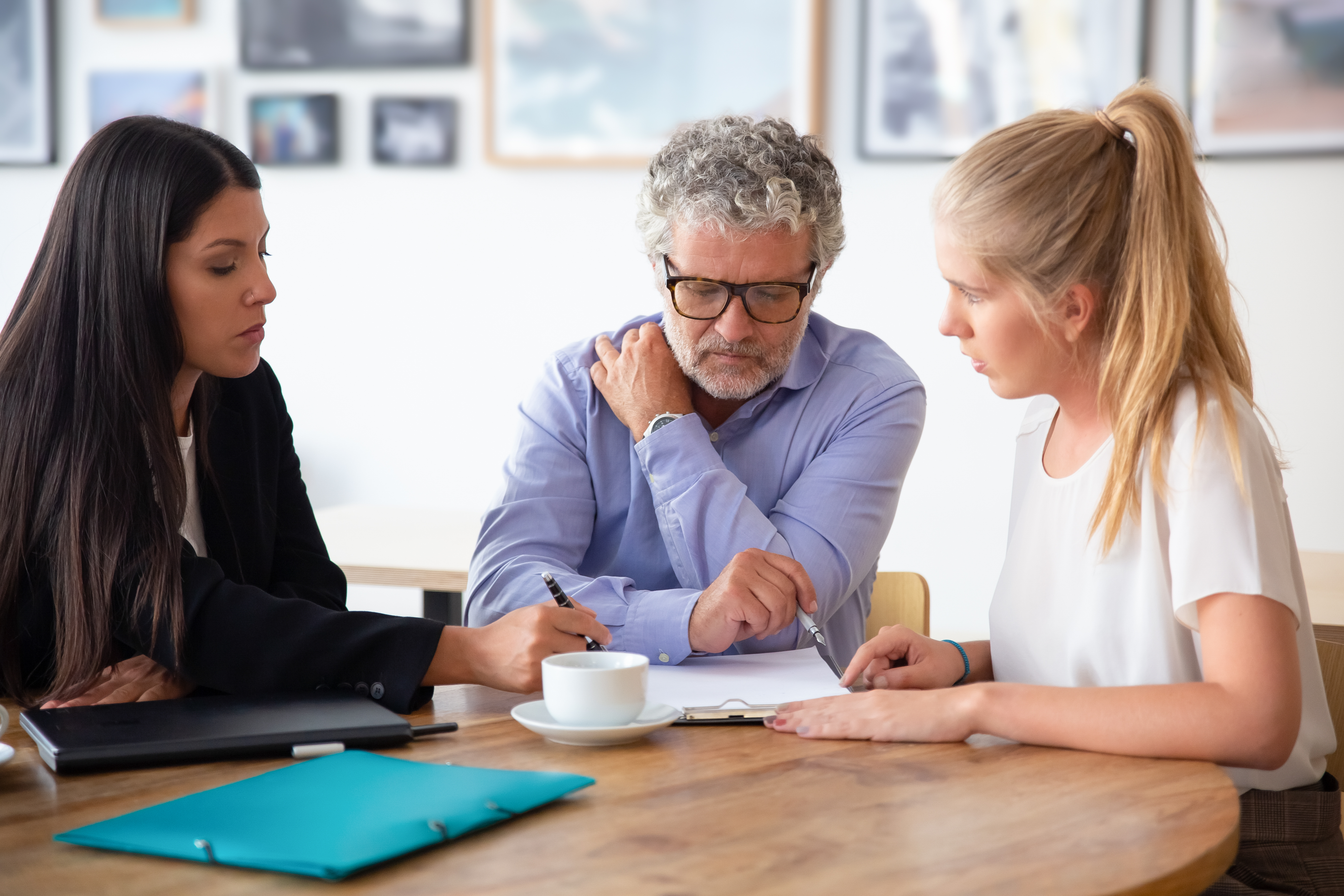 Father and adult daughter working with a tax adviser.
