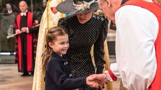 Catherine, Duchess of Cambridge introduces her daughter Princess Charlotte of Cambridge to the Archbishop of Canterbury Justin Welby as they arrive at Westminster Abbey for the Service of Thanksgiving for the Duke of Edinburgh on March 29, 2022 in London, England.
