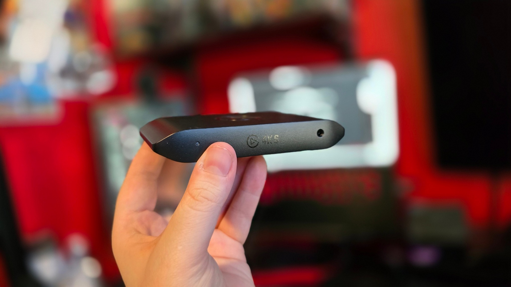 Photograph of the Jez Corden holding the Elgato 4K S capture card