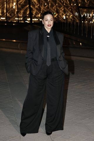 celebrity guests arrive at the inaugural grand diner du louvre in paris wearing designer fashion