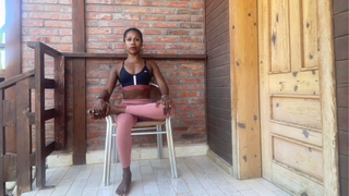 Aysha Bell doing the seated modified pigeon pose