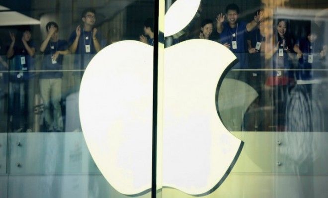 Apple staff members cheer before the Oct. 20 opening of the new Apple store in Wangfujing shopping district in Beijing.