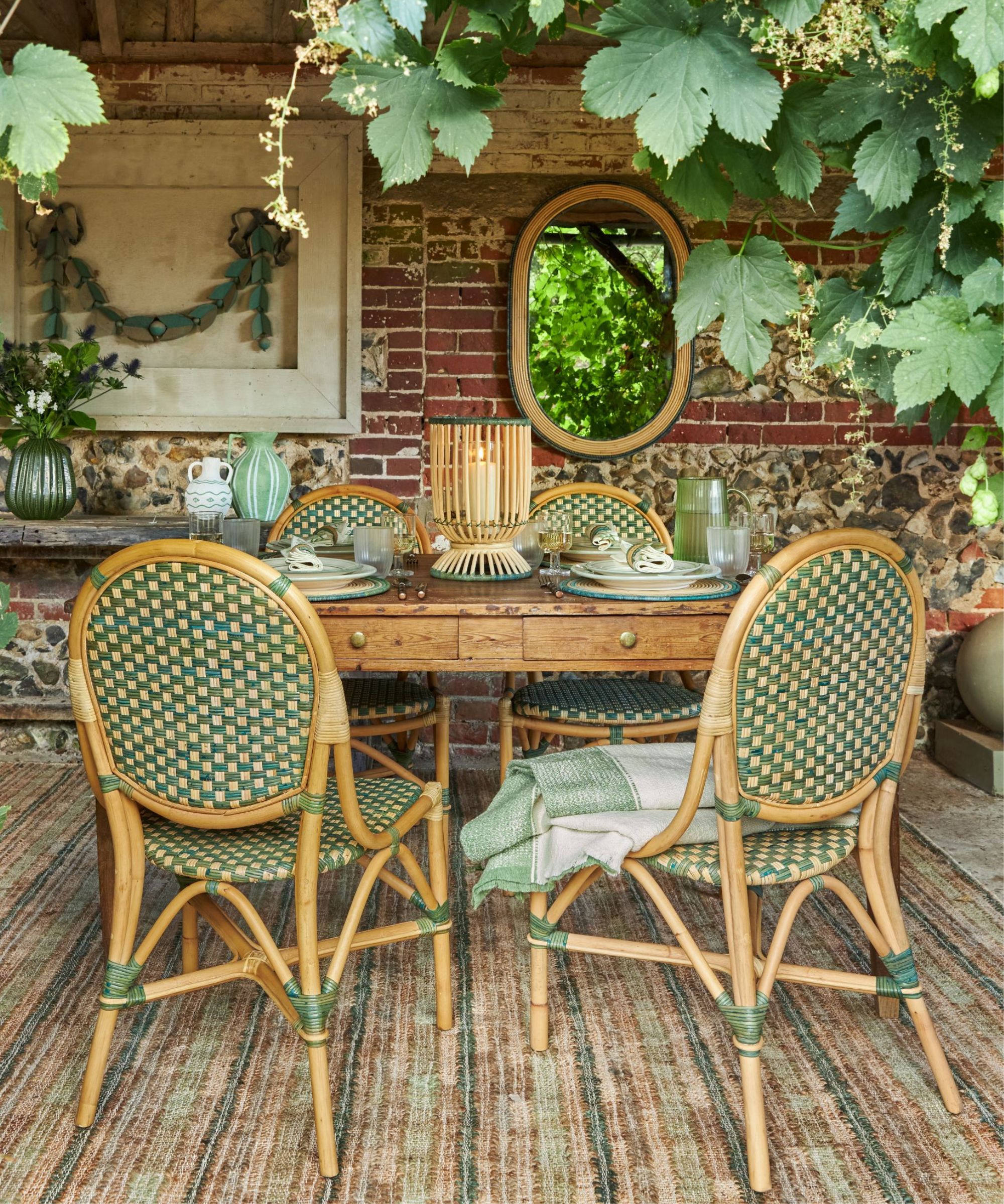 Wooden table with green wicker chairs