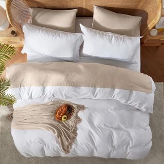 Nestl microfiber comforter on bed with four pillows and a taupe throw with breakfast in bed