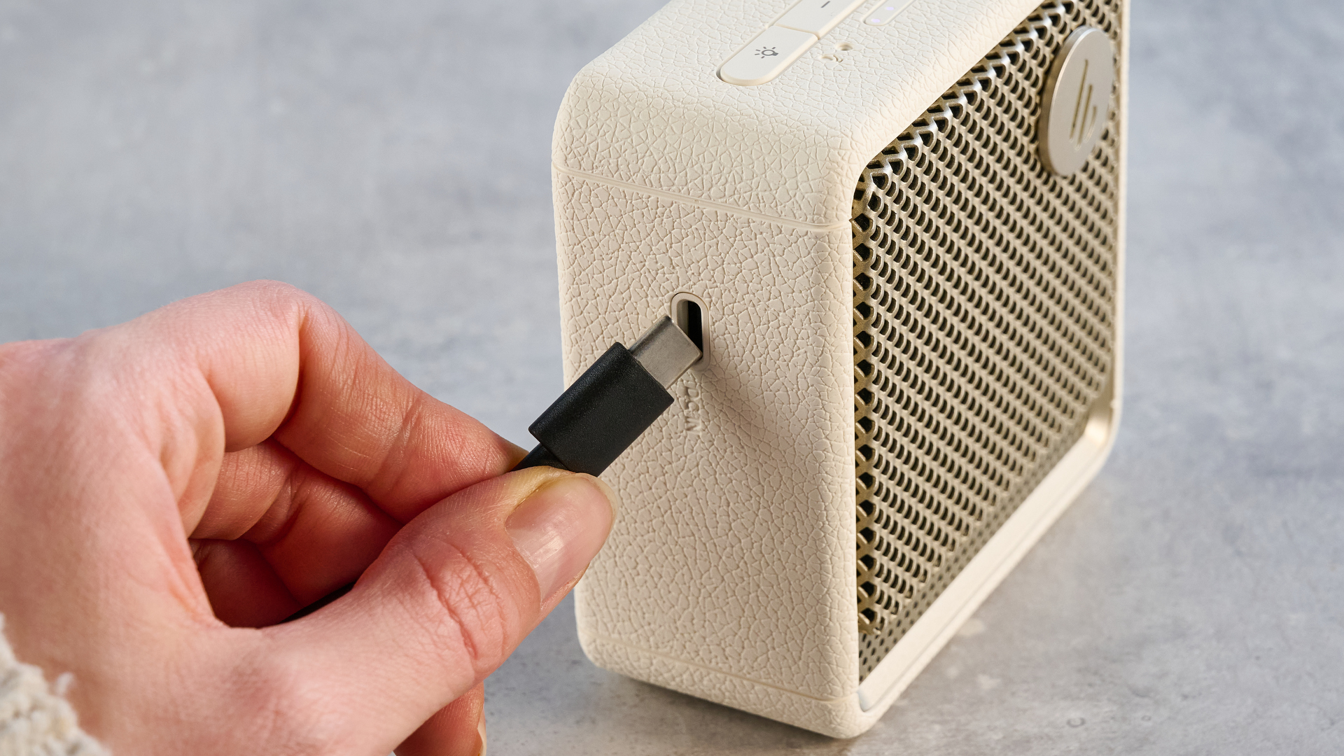 Edifier ES20 Bluetooth speaker in ivory colorway photographed on a blue background