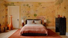Image of a spacious and elevated kids' room that has a black bed frame with white and pink bedding. The wallpaper is yellow with hand-painted drawings of the park.