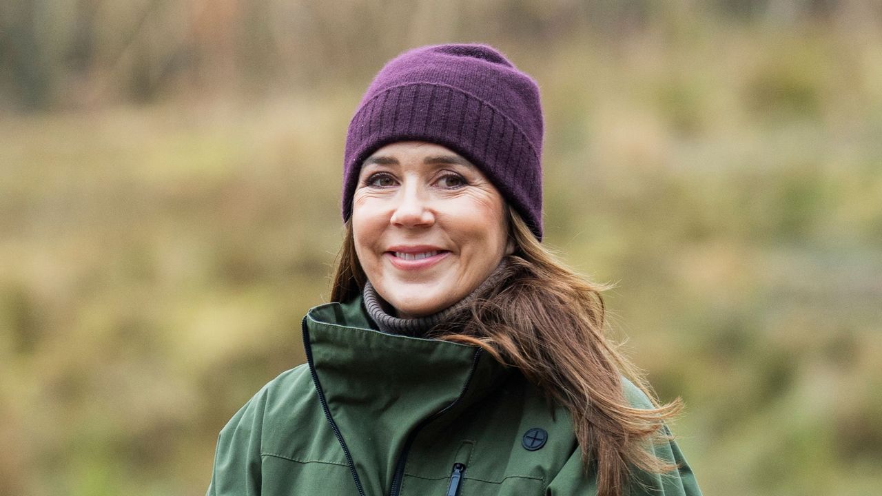 Queen Mary wearing khaki waterproof and plum beanie