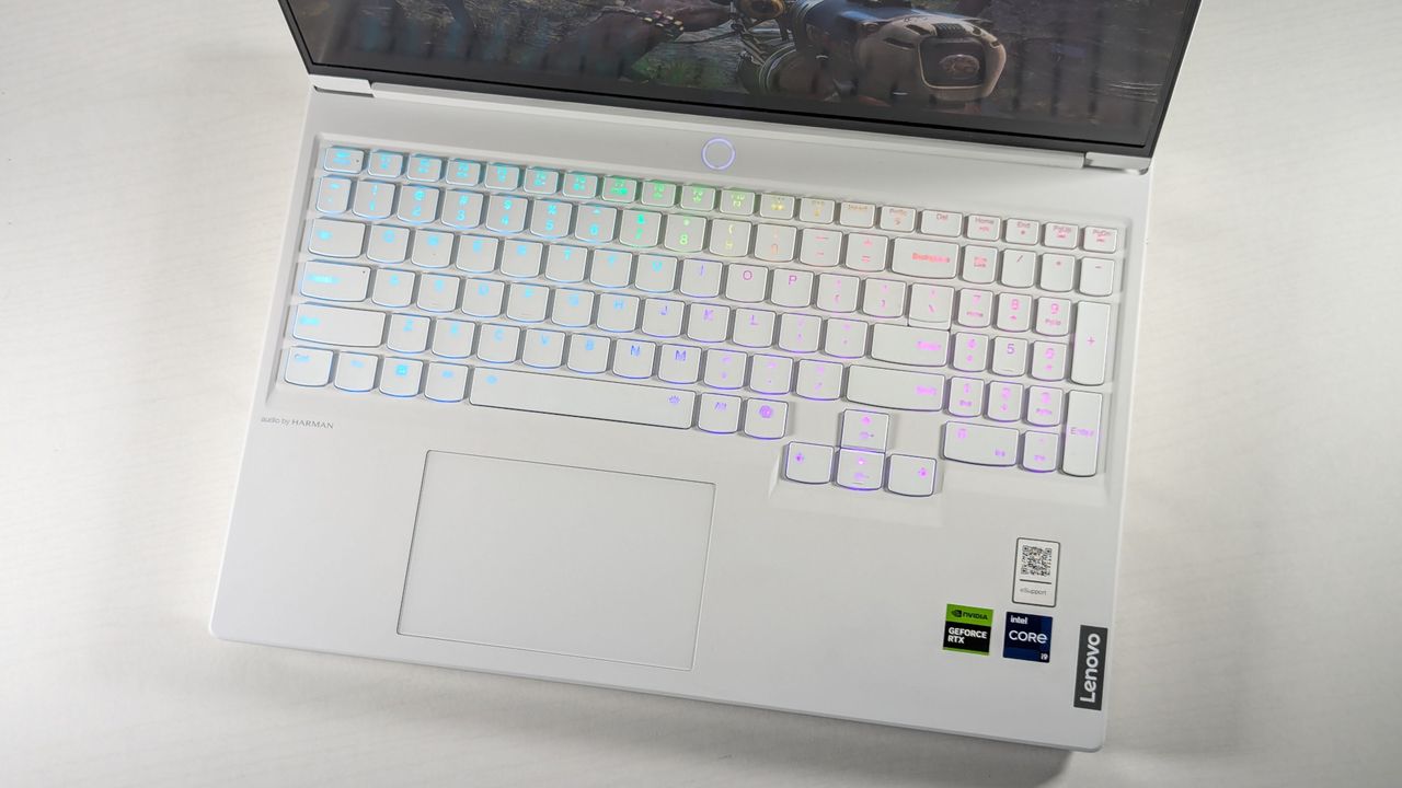Lenovo Legion 7i Gen 9 open on a white table, highlighting the RGB-lit keyboard against its white deck.