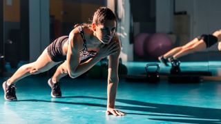 Woman doing plank shoulder taps