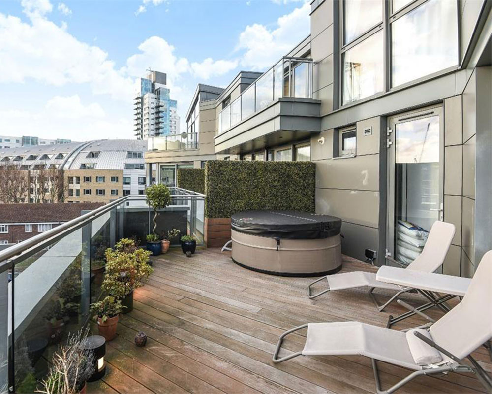 balcony with wooden flooring foldable recliner chairs and plants in pots