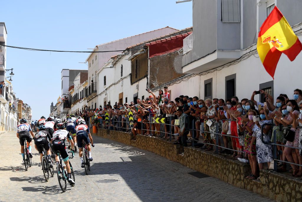 VILLANUEVA DE LA SERENA SPAIN AUGUST 27 A general view of Damiano Caruso of Italy and Team Bahrain Victorious polka dot mountain jersey Chris Hamilton of Australia and Team DSM Nicholas Schultz of Australia and Team BikeExchange Giulio Ciccone of Italy and Team Trek Segafredo and the peloton passing through Monterrubio de la Serena village while fans cheer during the 76th Tour of Spain 2021 Stage 13 a 2037km stage from Belmez to Villanueva de la Serena lavuelta LaVuelta21 on August 27 2021 in Villanueva de la Serena Spain Photo by Tim de WaeleGetty Images