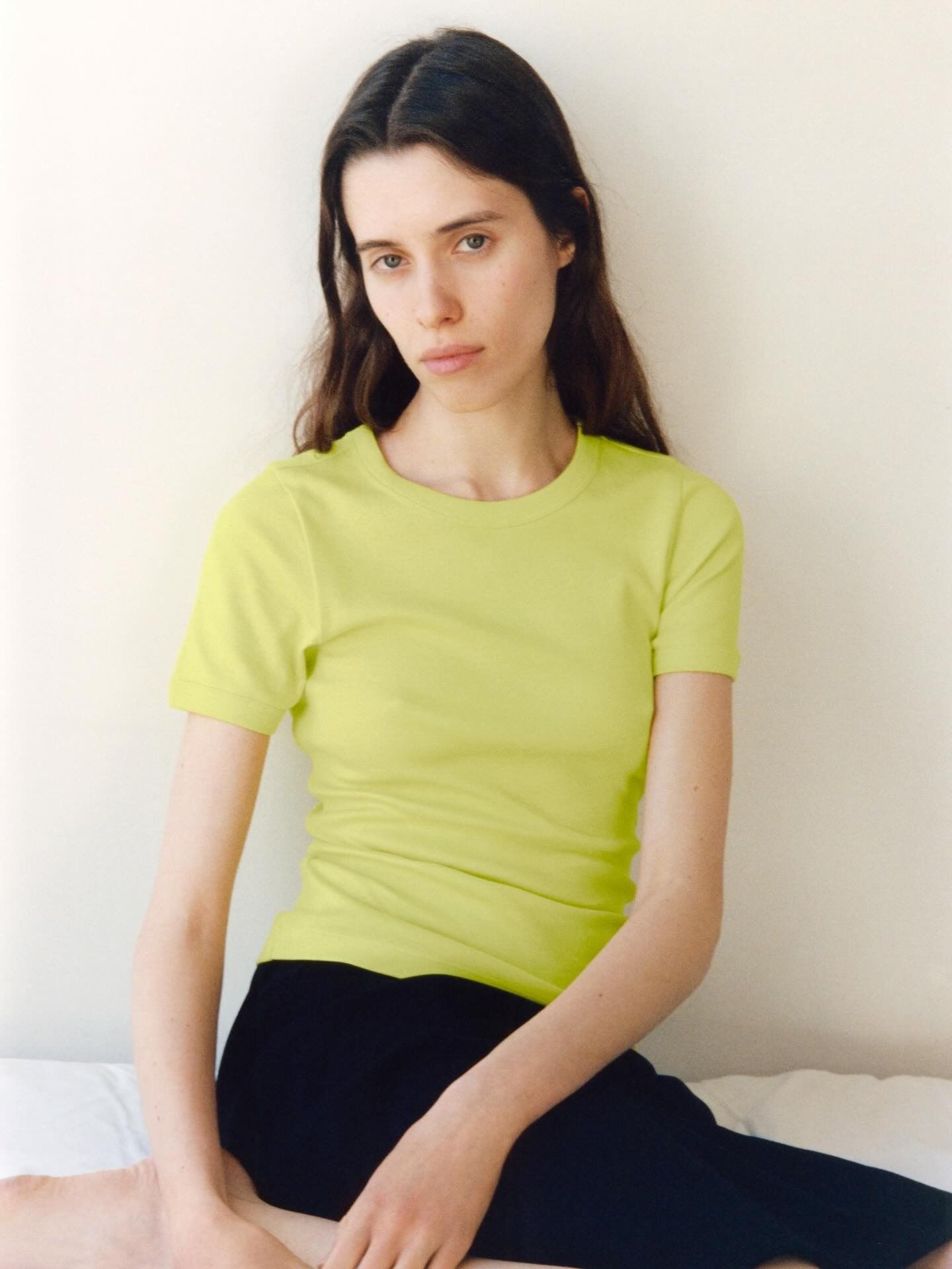 Woman wearing summer 2026 outfit featuring the colorful t-shirt trend.