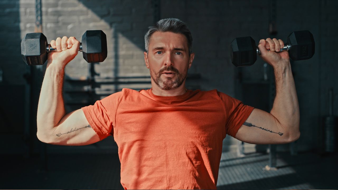 A man doing dumbbell shoulder press