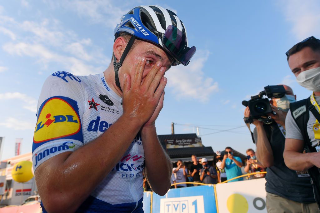 Evenepoel wipes the sweat away